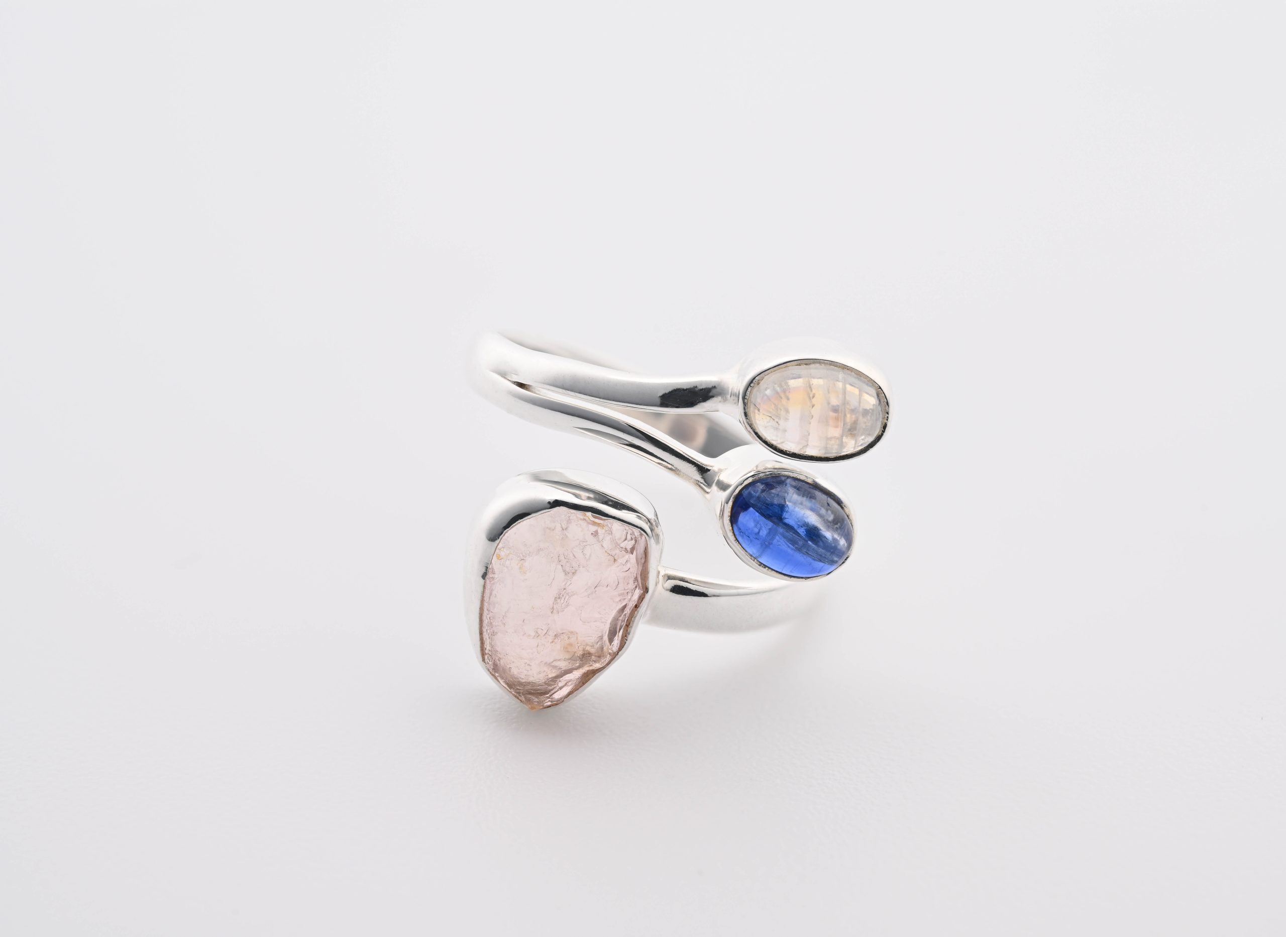 RQMSKN-7.5-7-RAINBOW-MOON-STONE-BLUE-KYANITE-ROSE-QUARTZ-RING-ADJUSTABLE-WHITE-BLUE-PINK-INDIA-BRAZIL-MADAGASCAR-POLISHED-RAW-FRONT-BAREFOOT-NATIVE.jpg Blue Kyanite (Brazil), Moonstone (India) Polished & Tanzanite (Tanzania) Rough Stones On .925 Ss Adjustable Ring Size 7.5 - Image 1